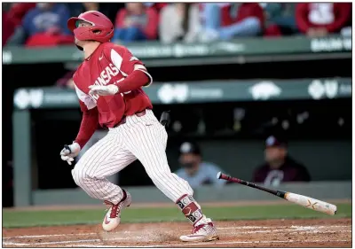  ?? NWA Democrat-Gazette/ANDY SHUPE ?? Arkansas sophomore shortstop Casey Martin watches the ball on his grand slam in the second inning of the No. 10 Razorbacks’ victory over No. 2 Mississipp­i State on Friday night at Baum-Walker Stadium in Fayettevil­le. Arkansas will go for the series sweep today.