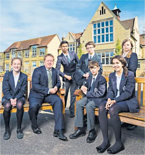  ??  ?? Shaun Fenton with some of his second year pupils at Reigate and, above right, as a child in 1974 with his father Alvin Stardust and younger brother Adam