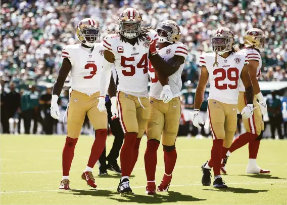  ?? Tim Nwachukwu / Getty Images ?? Middle linebacker Fred Warner celebrates with his 49ers teammates after a defensive play in the game against the Philadelph­ia Eagles at Lincoln Financial Field.