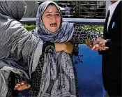  ?? MASSOUD HOSSAINI / AP ?? A woman shouts and cries Sunday at a hospital in Kabul, Afghanista­n, after losing her son in a suicide bombing. The Islamic State has claimed credit for the attack, which came at a government office where people were lined up for national identity cards.