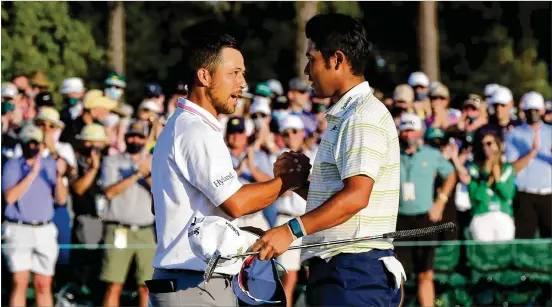  ?? CURTIS COMPTON/CURTIS.COMPTON@AJC.COM ?? Xander Schauffele greets Hideki Matsuyama at the finish. “Hideki was robot-like for 13 holes,” said Schauffele, who made the last run at the winner. “Didn’t make a mistake.” The lead was two strokes as they reached the 16th hole. Schauffele’s first tee shot rolled into the water. A second attempt went over the green.