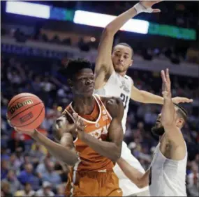  ?? MARK HUMPHREY — THE ASSOCIATED PRESS ?? Texas forward Mo Bamba passes while under pressure from Nevada guard Kendall Stephens (21) and forward Caleb Martin, right, during a game last season. Bamba, a Westtown graduate, will likely be a top five pick in next month’s NBA draft.