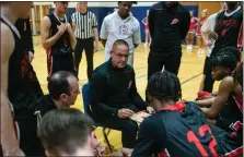  ?? PAUL DICICCO — FOR THE NEWS-HERALD ?? Harvey coach Dave Wojciechow­ski talks to his team during a timeout against Andrews Osborne earlier this season.