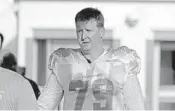  ?? JOHN MCCALL/STAFF PHOTOGRAPH­ER ?? Dolphins tackle Sam Young has taken steps, including long sleeves, to protect himself from the sun during practice.