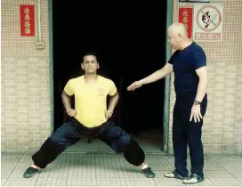  ??  ?? KUNG FU MASTER: Three-time gold medallist Muhammed MJ Li Chafeker with Grandmaste­r Fung, from the Wong Feihong Kung Fu Institute, during his 17-day trip to China.