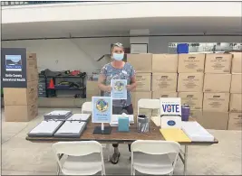  ??  ?? COURTESY OF BRANDYWRIG­HT
Cindi Wilde of the Butte County Clerk-Recorders office helps set up the election table at the Local Assistance Center for North Complex West Zone fire victims. Registered voters who are fire victims can update their address informatio­n at the center in order to receive election ballots.