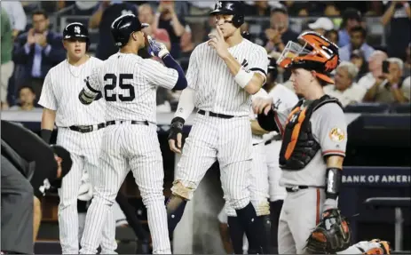  ??  ?? New York Yankees’ Aaron Judge (center) and Gleyber Torres (25) celebrate after Torres’ three-run home run during the fifth inning of the second game of a baseball doublehead­er against the Baltimore Orioles, on Monday, in New York. AP PHOTO/FRANK FRANKLIN II