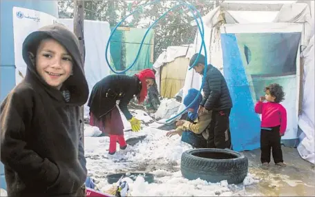  ?? Hassan Jarrah AFP/Getty Images ?? SYRIAN CHILDREN play in a refugee camp in Lebanon. Last year, the U.S. spent $110 million on programs in the country, including a playground meant to help curb extremism. President Trump has proposed deep spending cuts that could affect such foreign...