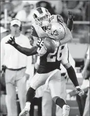  ?? D. Ross Cameron Associated Press ?? NEVIN LAWSON of the Raiders breaks up a pass intended for the Rams’ Alex Bachman in Oakland.