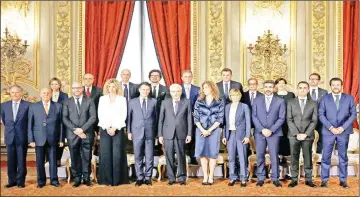  ??  ?? Mattarella poses with newly appointed Ministers after the sworn-in ceremony at the Quirinal palace in Rome. — Reuters photo