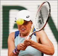  ?? Michel Euler / Associated Press ?? Iga Swiatek plays a shot against Danka Kovinic during their third-round match at the French Open on Saturday.