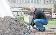  ??  ?? Robert Downie putting in a drainage system.