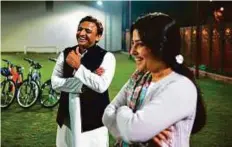  ?? AFP ?? Uttar Pradesh CM Akhilesh Yadav shares a lighter moment with his wife and member of Indian Parliament Dimple Yadav at home in Lucknow. Voting in the state begins today.