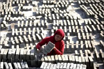  ?? — AFP photos ?? A Nepali labourer works at a brick factory in Bhaktapur.