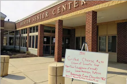  ?? BETSY SCOTT — THE NEWS-HERALD ?? Mentor Senior Center served its first curbside pickup meals March 16. The center has closed because of the coronaviru­s.
