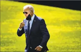  ?? Kent Nishimura Los Angeles Times ?? PRESIDENT BIDEN removes his mask after disembarki­ng Marine One outside the White House on Aug. 24. Recently, Biden said the pandemic “is over.”
