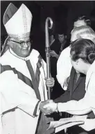  ?? RICHARD GARDNER, THE COMMERCIAL APPEAL ?? Bishop Carroll T. Dozier, of the Catholic Diocese of Memphis, shakes hands with Dr. and Mrs. David Taylor during a procession­al on May 21, 1971.