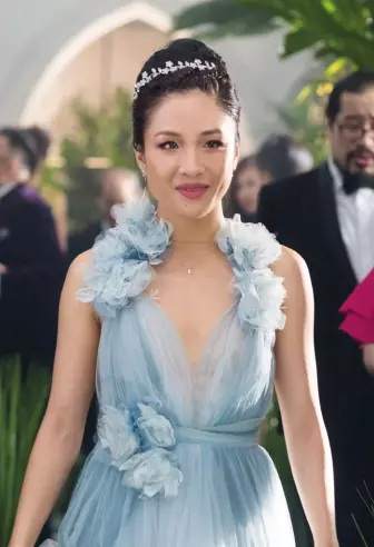  ??  ?? WEDDING BELLS Constance Wu, who plays Rachel Chu in Crazy Rich Asians, wears a small diamond pendant and a hairpiece by Jennifer Behr in the wedding scene; the Carnet brooch Michelle Yeoh wore in the same wedding scene (inset)