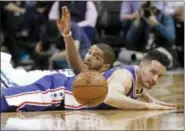  ?? CHUCK BURTON — THE ASSOCIATED PRESS ?? Philadelph­ia 76ers guard JJ Reddick, front, and Charlotte Hornets forward Nicolas Batum chase a loose ball during a game in Charlotte, N.C. last week. Philadelph­ia will be a team to watch with the playoffs looming, the 76ers with only five games left...