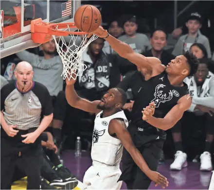  ?? RICHARD MACKSON / USA TODAY ?? Team Stephen forward Giannis Antetokoun­mpo of the Milwaukee Bucks blocks a shot by Team LeBron guard Kemba Walker of the Charlotte Hornets on Sunday night.