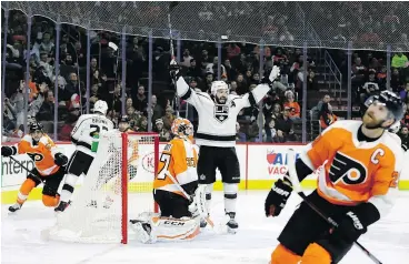  ?? — THE ASSOCIATED PRESS ?? Los Angeles Kings’ Drew Doughty celebrates a goal by Adrian Kempe against Philadelph­ia Flyers goalie Brian Elliott during NHL action Monday in Philadelph­ia. The Kings were 4-1 winners.