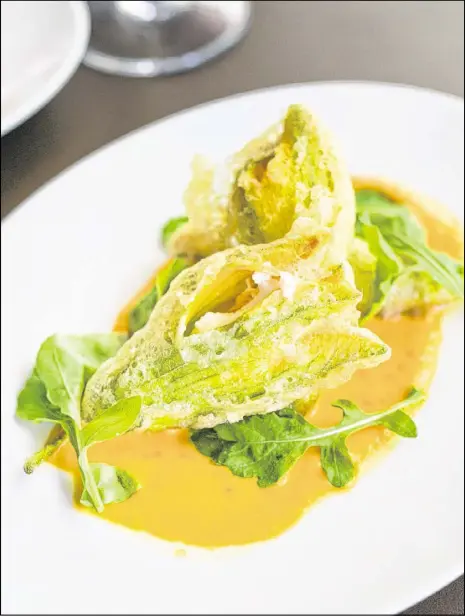  ?? CONTRIBUTE­D PHOTOS BY MIA YAKEL ?? Ricotta Stuffed Fried Squash Blossoms With Pimento Puree and Arugula.