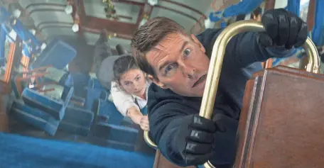  ?? PROVIDED BY PARAMOUNT/SKYDANCE ?? Secret agent Ethan Hunt (Tom Cruise) and the mysterious thief Grace (Hayley Atwell) try to survive a trip on the Orient Express in the action movie “Mission: Impossible – Dead Reckoning Part One.”