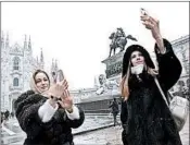  ?? MIGUEL MEDINA/GETTY-AFP ?? Tourists take selfies last week in Italy. The tip of the nose appears 7 percent wider in selfies, according to a study.