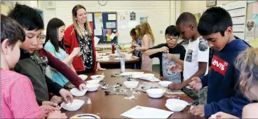  ?? HERALD PHOTO BY ALEJANDRA PULIDO-GUZMAN ?? Red seal chef and restaurant owner, Candice Klassen guides Grade 4 students on how to make popcorn spices as part of their STEAM activities Thursday at Our Lady of the Assumption school.