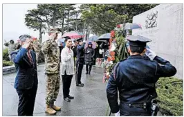  ?? ERIC RISBERG/AP ?? U.S. and Philippine officials attend a ceremony in San Francisco marking the 1942 march.