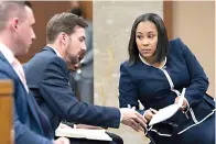  ?? AP Photo/Ben Gray ?? Fulton County District Attorney Fani Willis, right, talks with a member of her team during proceeding­s to seat a special purpose grand jury Monday in Fulton County, Georgia, to look into the actions of former President Donald Trump and his supporters who tried to overturn the results of the 2020 election. The hearing took place in Atlanta.