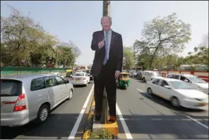  ?? (AP/Ajit Solanki) ?? A life-size cutout of President Donald Trump is displayed on a road divider Saturday ahead of Trump’s visit to Ahmedabad, India.