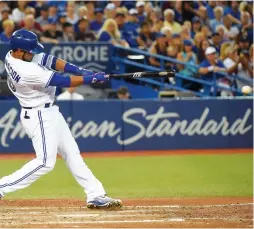  ?? (Reuters) ?? TORONTO BLUE JAYS first baseman Edwin Encarnacio­n hits a two-run single – his MLB-leading 93rd and 94th RBIs of the season – against the Tampa Bay Rays in the fourth inning of the Jays’ 7-5 home victory on Monday night.