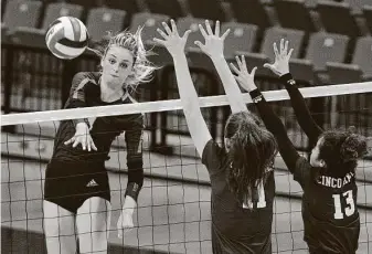  ?? Craig Moseley / Contributo­r ?? Ally Batenhorst, spiking the ball past Cinco Ranch’s Krystyna Podskarbi, left, and Catalina Martinez in a regional quarterfin­al, had 574 kills, 32 aces, 33 blocks and 371 digs in 2020.