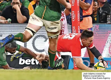  ?? ?? Josh Adams crosses for Wales’s crucial late try.
Picture: Huw Evans Agency