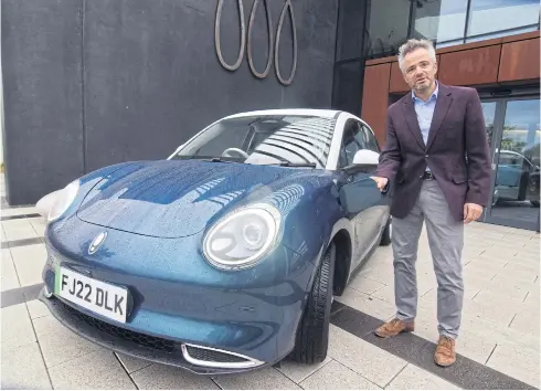  ?? REUTERS ?? Toby Marshall, UK sales and marketing director for Great Wall Motor’s ORA brand, shows off the fully electric ORA Funky Cat hatchback ahead of its British launch in Solihull, Britain on Oct 5.