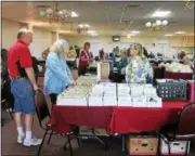  ??  ?? Shoppers and vendors at the 43rd annual Post Card Show, held Sunday at the Troy Elks Lodge.