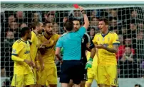  ?? AFP ?? English referee Michael Oliver (back to camera) shows a red card to Gianluigi Buffon (second right) during the match. —