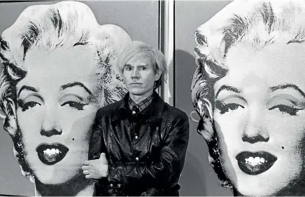  ?? GETTY IMAGES ?? American pop-art painter and film-maker Andy Warhol stands in front of his double portrait of Marilyn Monroe in London.