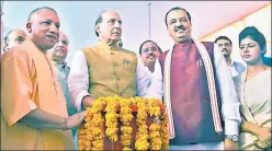  ??  ?? Union home minister Rajnath Singh (centre) unveiling the projects in the presence of CM Yogi ▪
Adityanath and deputy CM Keshav Prasad Maurya.