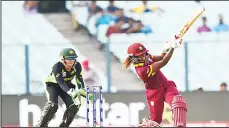  ??  ?? West Indies’ Hayley Matthews (right), is watched by Australia’s Alyssa Healy as she plays a shot during the World T20 cricket tournament women’s final match between Australia and West Indies at the Eden Gardens Cricket Stadium in Kolkata on April 3.