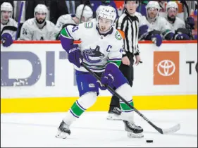  ?? Nick Wass The Associated Press ?? Vancouver’s Quinn Hughes leads all defensemen in the NHL in scoring with 65 points this season.