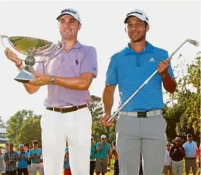  ?? — AFP ?? Happy day: Justin Thomas (left) holding the FedEx Cup trophy while Xander Schauffele poses with the Calamity Jane trophy after the final round of the Tour Championsh­ip at the East Lake Golf Club in Atlanta, Georgia, on Sunday.