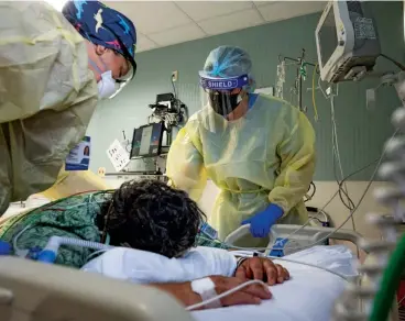  ?? ?? TREATMENT OPTIONS Nurses tend to a COVID-19 patient at St. Joseph Hospital in Orange, California.