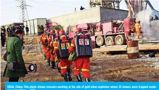  ?? AFP ?? QIXIA, China: This photo shows rescuers working at the site of gold mine explosion where 22 miners were trapped undergroun­d in Qixia.—