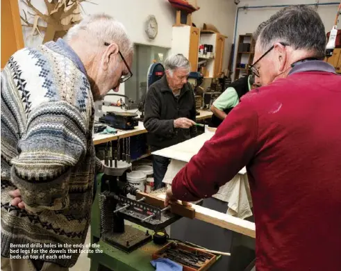  ??  ?? Bernard drills holes in the ends of the bed legs for the dowels that locate the beds on top of each other