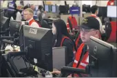  ??  ?? JEFF CHIU — THE ASSOCIATED PRESS FILE Pacific Gas & Electric employees work in the PG&E Emergency Operations Center in San Francisco.