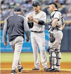  ?? Getty Images ?? NOT HIS DAY: Pitching coach Larry Rothschild and catcher Gary Sanchez come out to the mound to speak to Masahiro Tanaka in the third inning of Saturday’s loss.