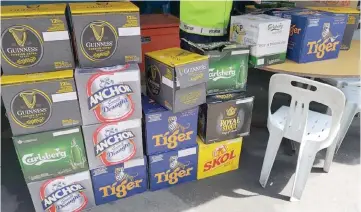  ??  ?? Boxes containing bottled beers of various brands are seen stacked outside one of the premises in Pelita Commercial Centre. It is suspected that these alcoholic beverages are being sold without the proper licence.