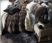  ?? PHOTO COURTESY OF BED BATH & BEYOND ?? And you thought UGG only created great boots. These warm and comfortabl­e faux fur throws and pillows are a must this season.